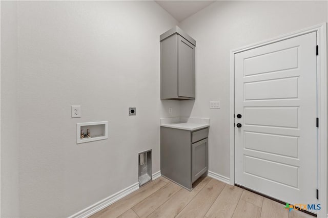 301 Canyon Oaks Rd, Troy, TX 76579 - laundry room featuring electric dryer hookup, cabinet space, baseboards, light wood finished floors, and hookup for a washing machine