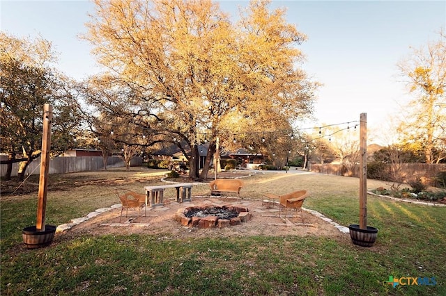 view of yard featuring fence and an outdoor fire pit