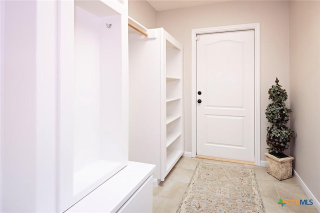 mudroom with light tile patterned floors and baseboards