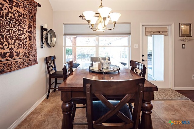 dining area with baseboards and an inviting chandelier