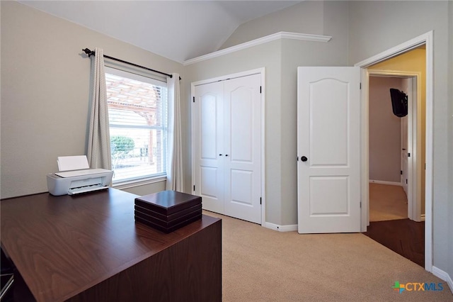 unfurnished office featuring lofted ceiling, baseboards, and carpet floors