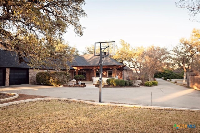 view of sport court featuring a lawn