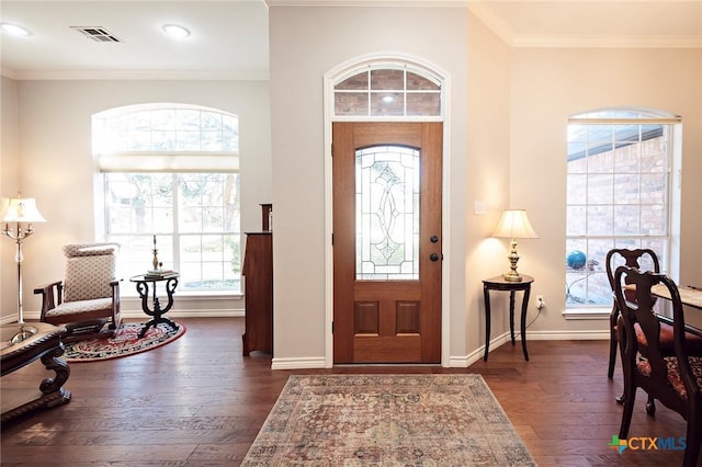 entrance foyer featuring visible vents, crown molding, baseboards, and dark wood-style flooring