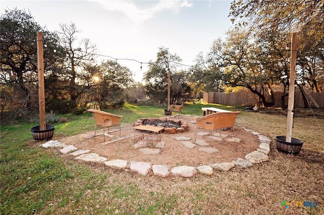 view of yard with a fire pit and fence