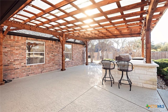 view of patio / terrace with fence, a pergola, and outdoor dry bar