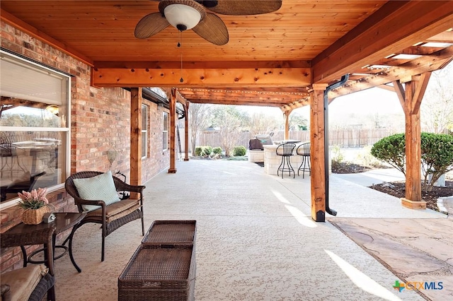 view of patio with a ceiling fan, outdoor dining area, and fence