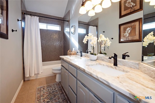 bathroom featuring tile patterned flooring, shower / tub combo, toilet, and a sink