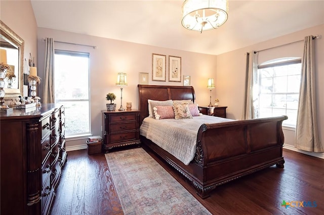 bedroom featuring baseboards and dark wood-style floors