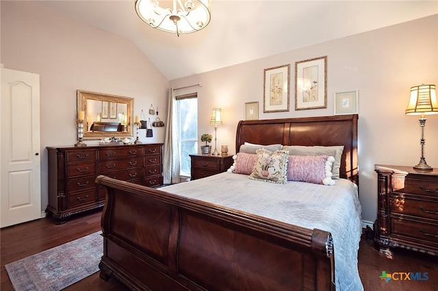 bedroom with a chandelier, dark wood-style floors, and vaulted ceiling