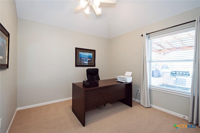 office area with light carpet, a ceiling fan, and baseboards