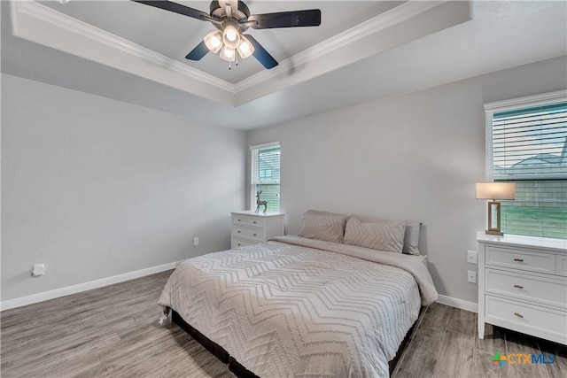 7611 Iridium Dr, Killeen, TX 76542 - bedroom with a raised ceiling, ornamental molding, wood finished floors, baseboards, and ceiling fan