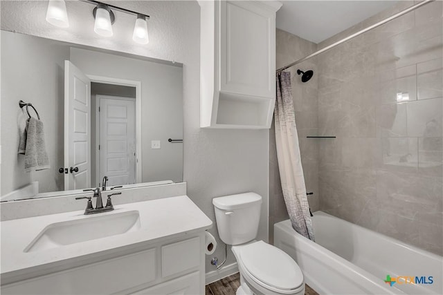 7611 Iridium Dr, Killeen, TX 76542 - full bath with shower / bath combo with shower curtain, vanity, toilet, and wood finished floors