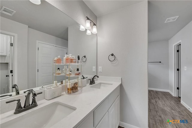 7611 Iridium Dr, Killeen, TX 76542 - bathroom with baseboards, wood finished floors, and double vanity