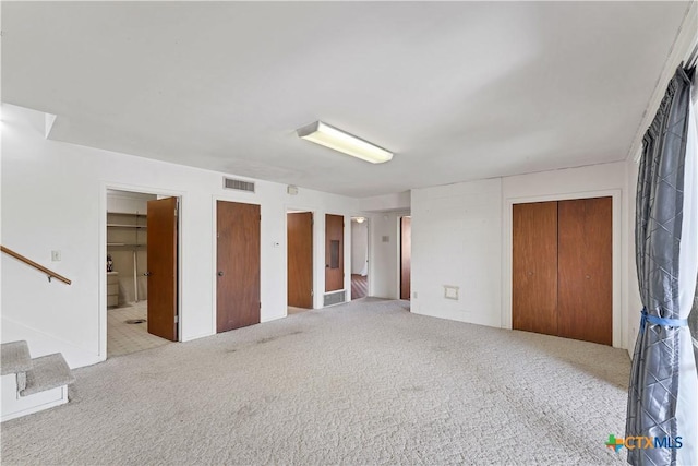 667 Fredericksburg Rd, New Braunfels, TX 78130 - carpeted empty room featuring stairway and visible vents