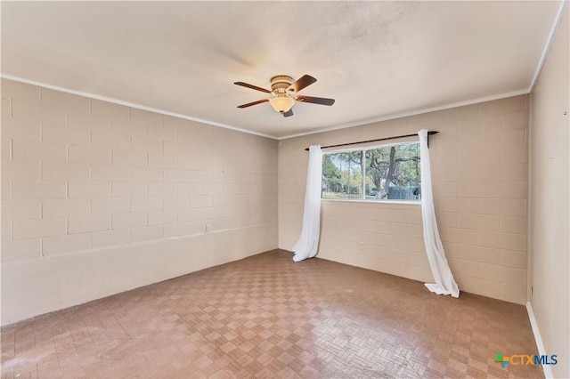 667 Fredericksburg Rd, New Braunfels, TX 78130 - spare room with concrete block wall, ceiling fan, and crown molding