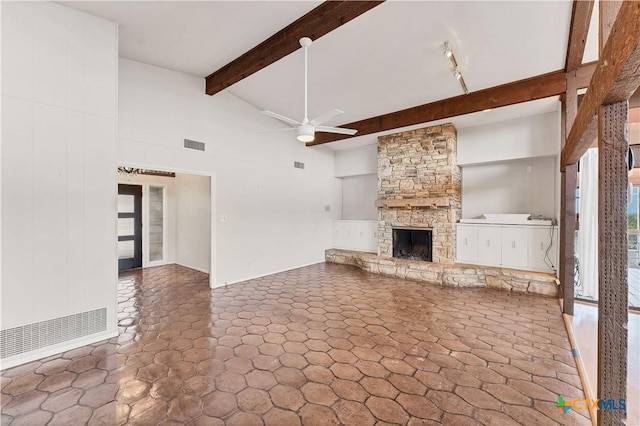667 Fredericksburg Rd, New Braunfels, TX 78130 - unfurnished living room featuring a ceiling fan, visible vents, high vaulted ceiling, a fireplace, and beamed ceiling