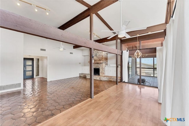 667 Fredericksburg Rd, New Braunfels, TX 78130 - interior space featuring a fireplace, beamed ceiling, a ceiling fan, and visible vents