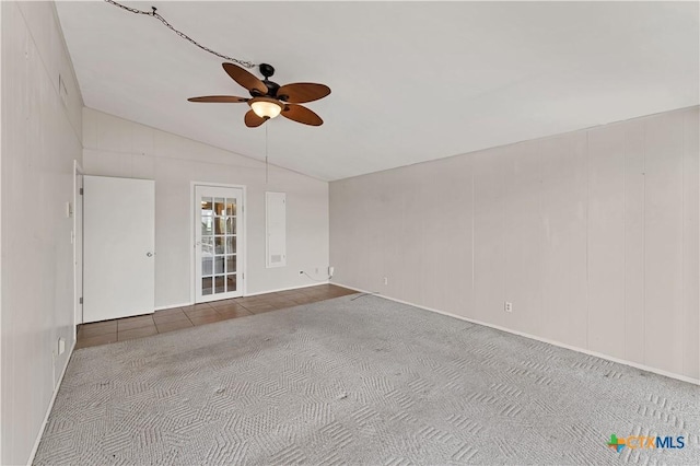 667 Fredericksburg Rd, New Braunfels, TX 78130 - unfurnished room featuring tile patterned floors, lofted ceiling, a ceiling fan, and carpet flooring