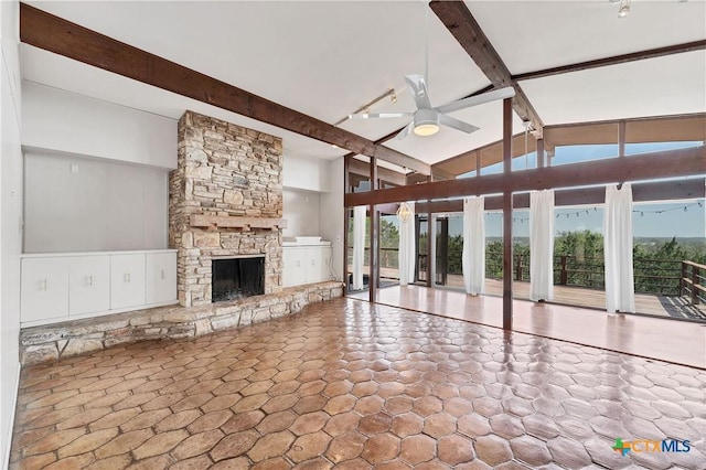 667 Fredericksburg Rd, New Braunfels, TX 78130 - unfurnished living room with a stone fireplace, beam ceiling, high vaulted ceiling, and ceiling fan