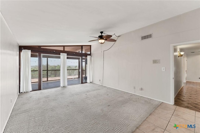 667 Fredericksburg Rd, New Braunfels, TX 78130 - carpeted spare room with visible vents, lofted ceiling, ceiling fan, and tile patterned flooring