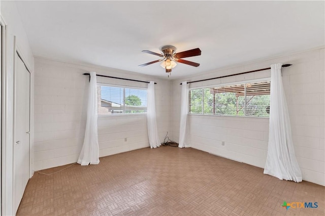 667 Fredericksburg Rd, New Braunfels, TX 78130 - spare room with concrete block wall and ceiling fan