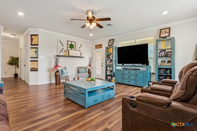 living room featuring wood-type flooring, ceiling fan, and crown molding