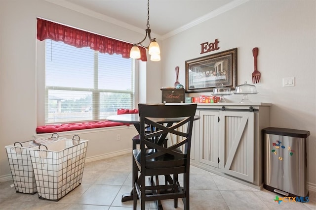 dining room with a chandelier, light tile patterned floors, and crown molding