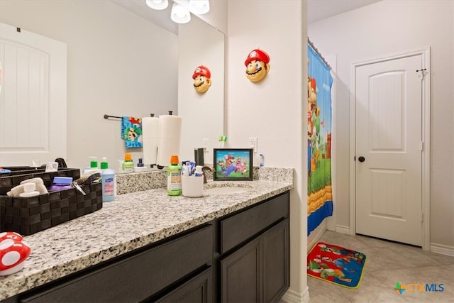 bathroom featuring walk in shower, vanity, and tile patterned floors