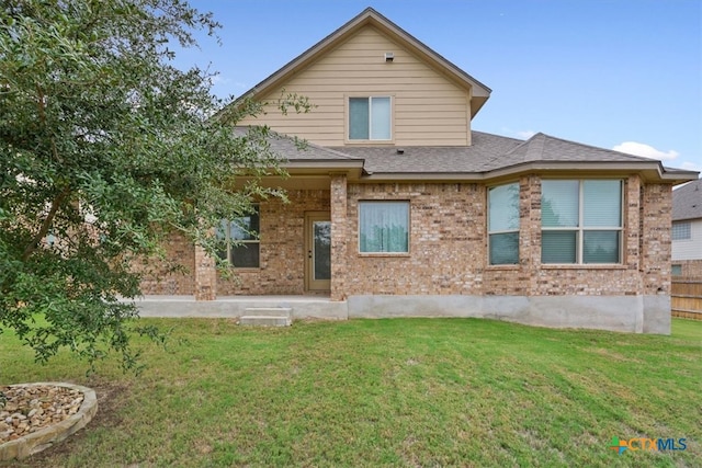 rear view of house with a yard