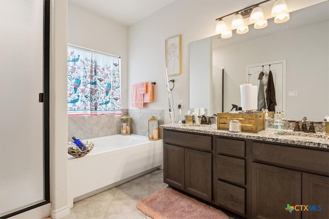 bathroom with vanity, tile patterned floors, and a bathing tub