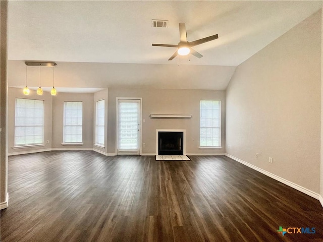 1715 Ramona Cir, San Marcos, TX 78666 - unfurnished living room with dark wood-type flooring, a ceiling fan, a fireplace with flush hearth, and vaulted ceiling