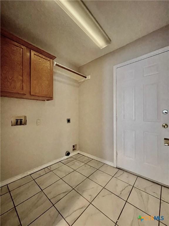 1715 Ramona Cir, San Marcos, TX 78666 - laundry area with hookup for an electric dryer, hookup for a washing machine, cabinet space, and light marble finish floors