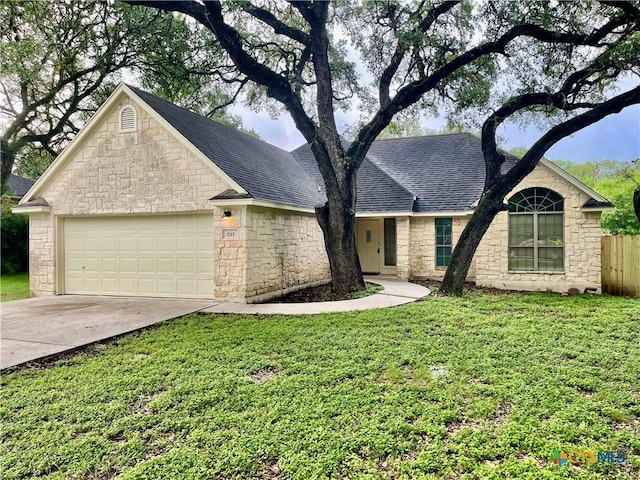 1715 Ramona Cir, San Marcos, TX 78666 - single story home featuring stone siding, roof with shingles, driveway, and a garage