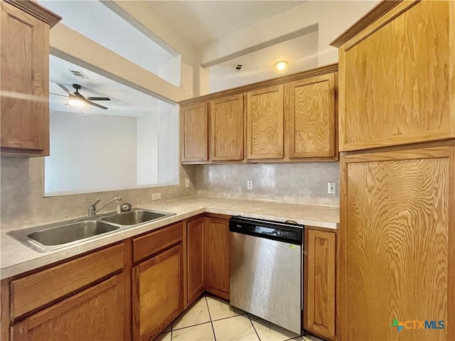 1715 Ramona Cir, San Marcos, TX 78666 - kitchen with dishwasher, light tile patterned floors, ceiling fan, light countertops, and brown cabinets