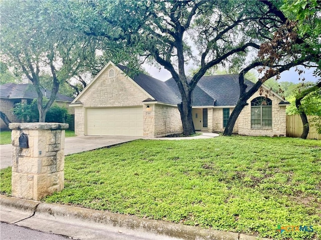1715 Ramona Cir, San Marcos, TX 78666 - single story home featuring stone siding, driveway, and a garage