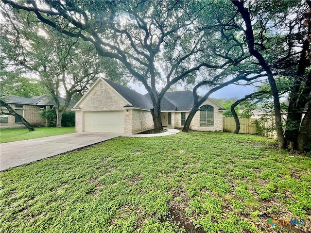 1715 Ramona Cir, San Marcos, TX 78666 - ranch-style house with stone siding, a garage, and concrete driveway