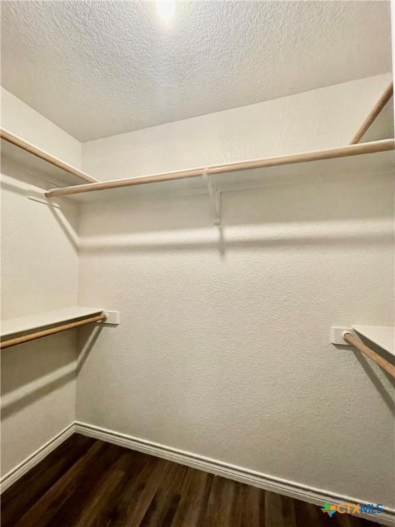 1715 Ramona Cir, San Marcos, TX 78666 - walk in closet featuring dark wood-type flooring