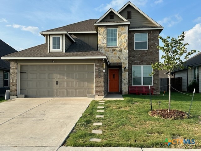 view of front of property with a front lawn and a garage