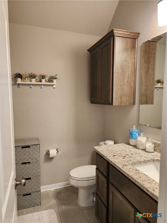 bathroom featuring tile patterned floors, vanity, and toilet