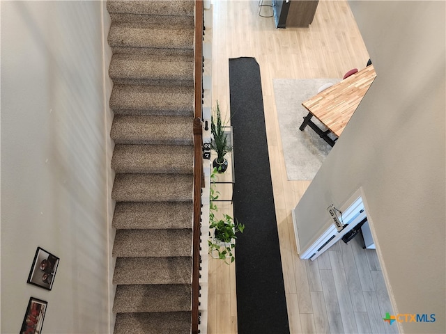 stairs with hardwood / wood-style flooring