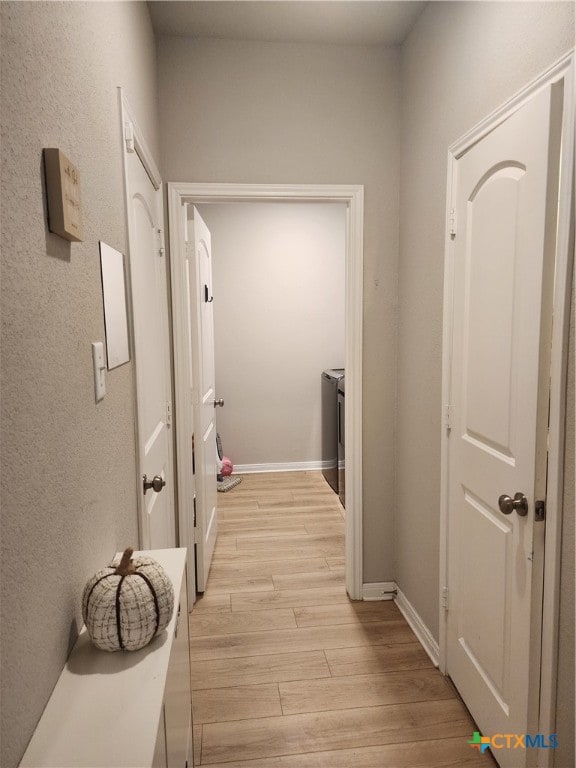 corridor with light wood-type flooring