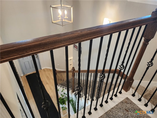 stairway featuring an inviting chandelier