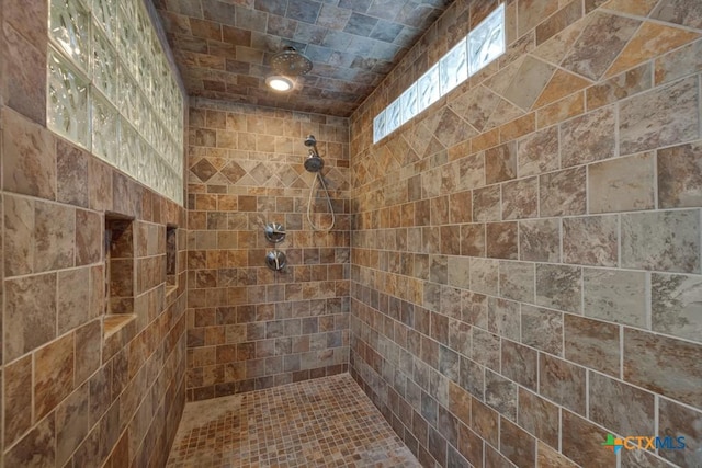 bathroom with tiled shower