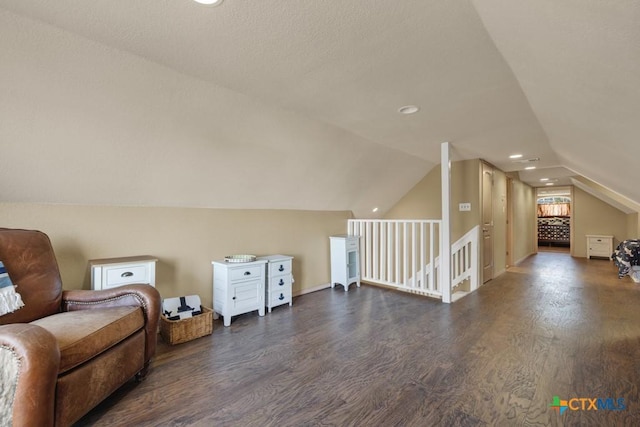 bonus room with lofted ceiling and dark wood-type flooring