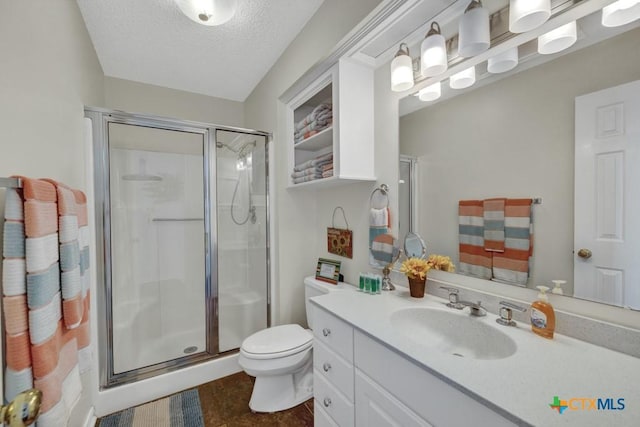 bathroom with vanity, toilet, a textured ceiling, and walk in shower