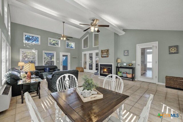 dining area with french doors, high vaulted ceiling, light tile patterned floors, ceiling fan, and beam ceiling