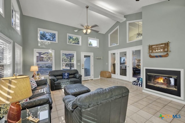 living room with ceiling fan, tile patterned floors, and high vaulted ceiling