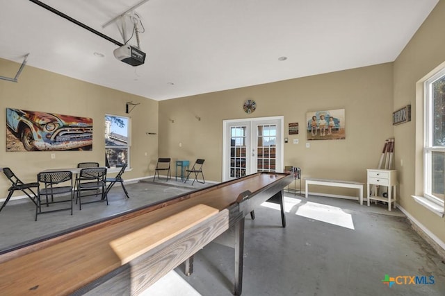 rec room featuring concrete floors and french doors