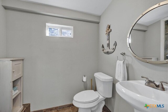 bathroom featuring tile patterned floors, toilet, and sink