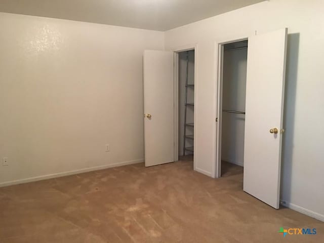 unfurnished bedroom featuring light colored carpet